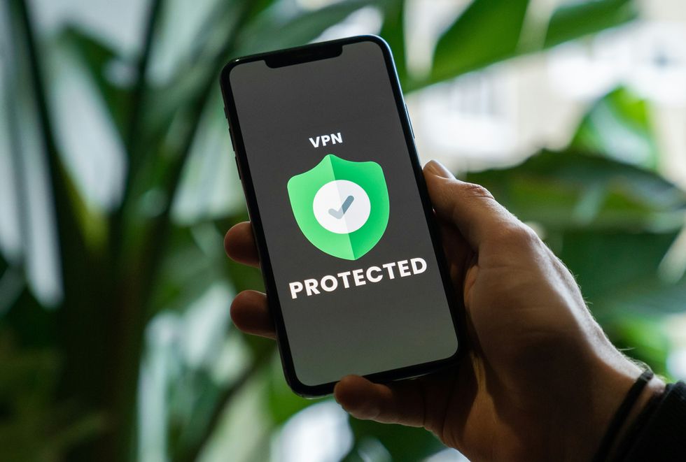 hand holding a smartphone with a VPN on-screen  