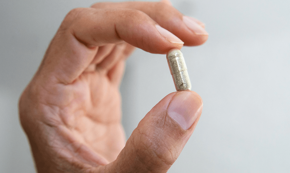 Hand holding a supplement