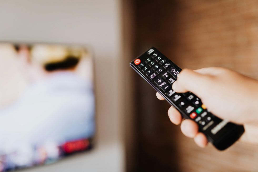 Hand holding a TV remote