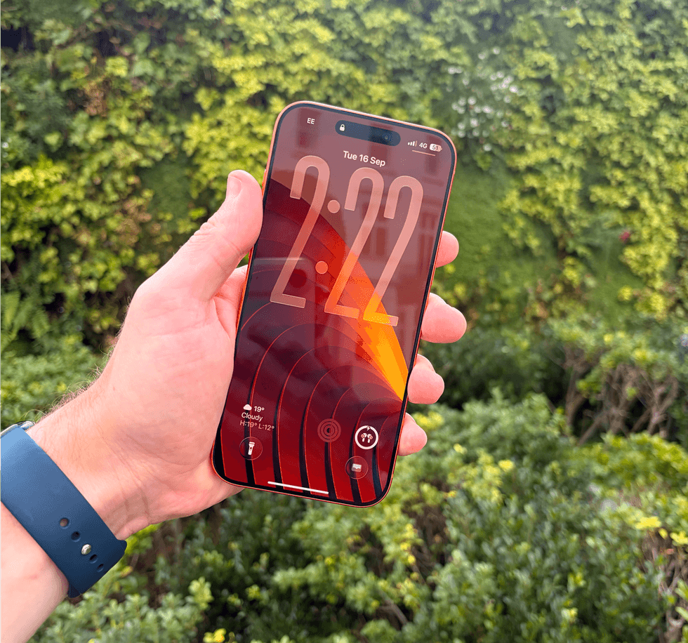 hand holding iPhone 17 pro max outside