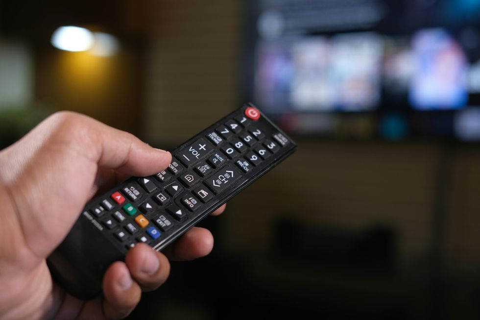 Hand holding TV remote
