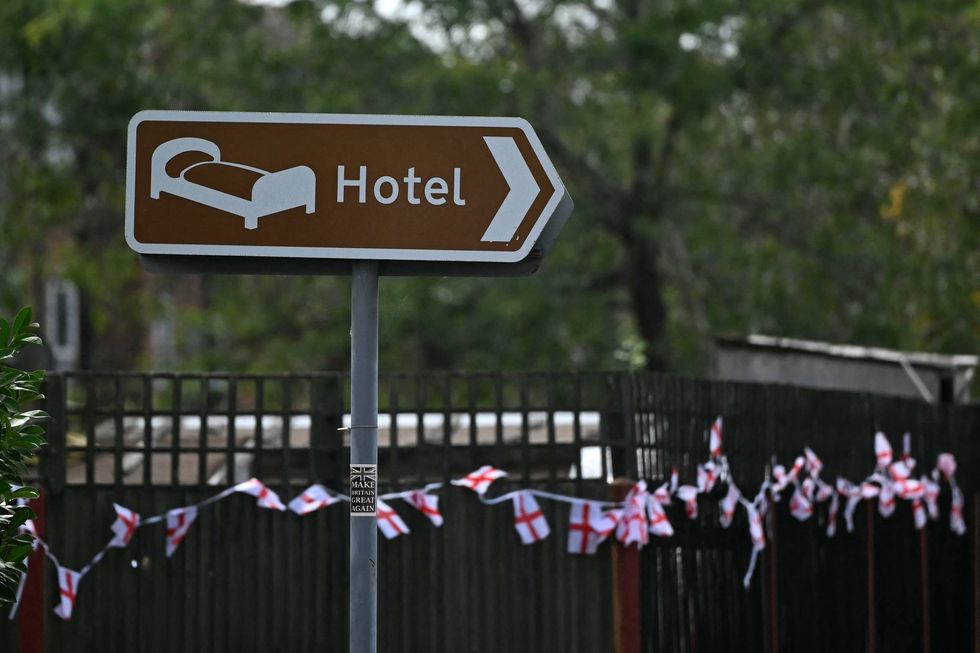 Hotel sign with England flags in background