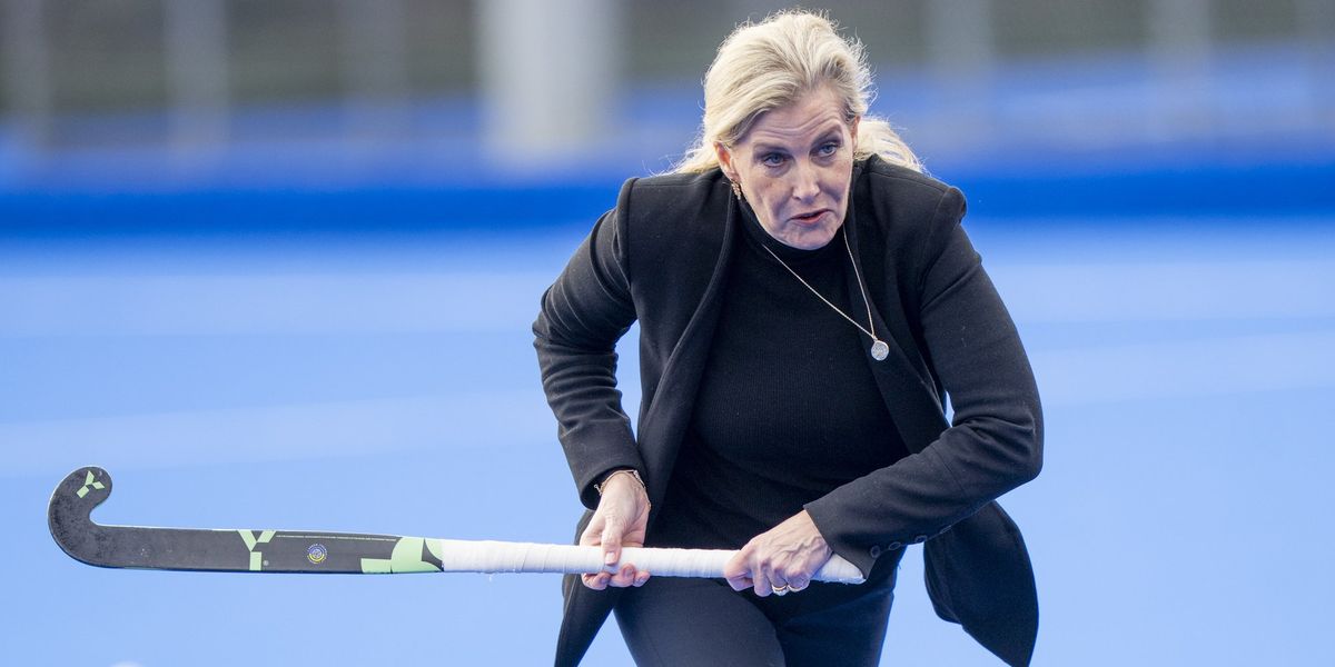 Duchess of Edinburgh wallops hockey balls while wearing a blazer during royal engagement