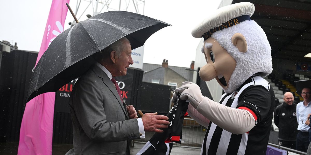King Charles delighted as he is receives personalised football shirt from club mascot