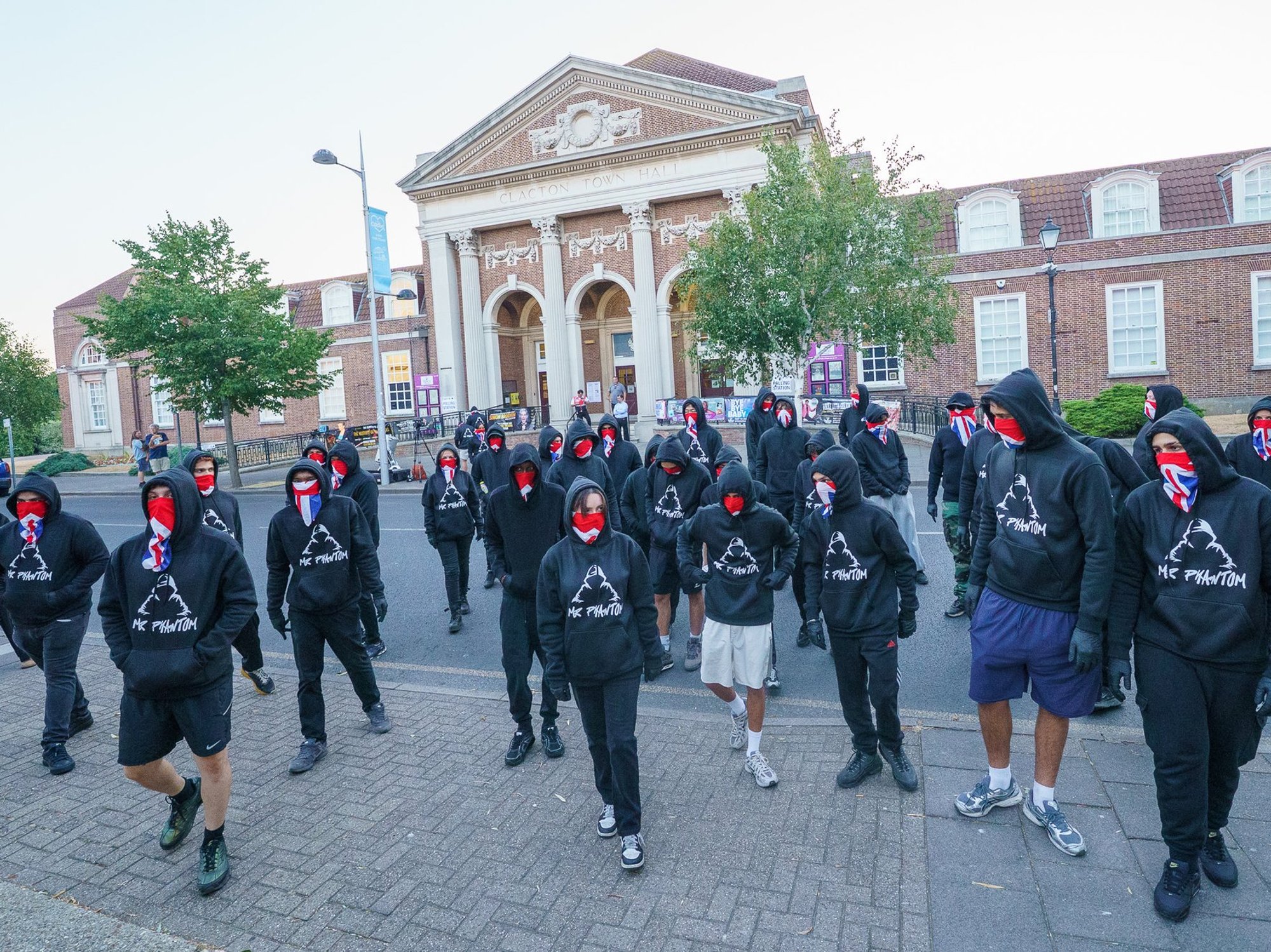 In photographs seen by GB News, the black-clad group stood outside one of the seaside seat's polling stations wearing Union Jack face masks