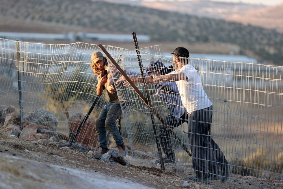 Israeli settlers breaching fencing in the Christian village of Taybeh