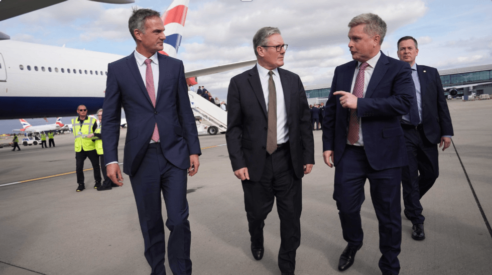 Keir Starmer with advisers before boarding plane to India