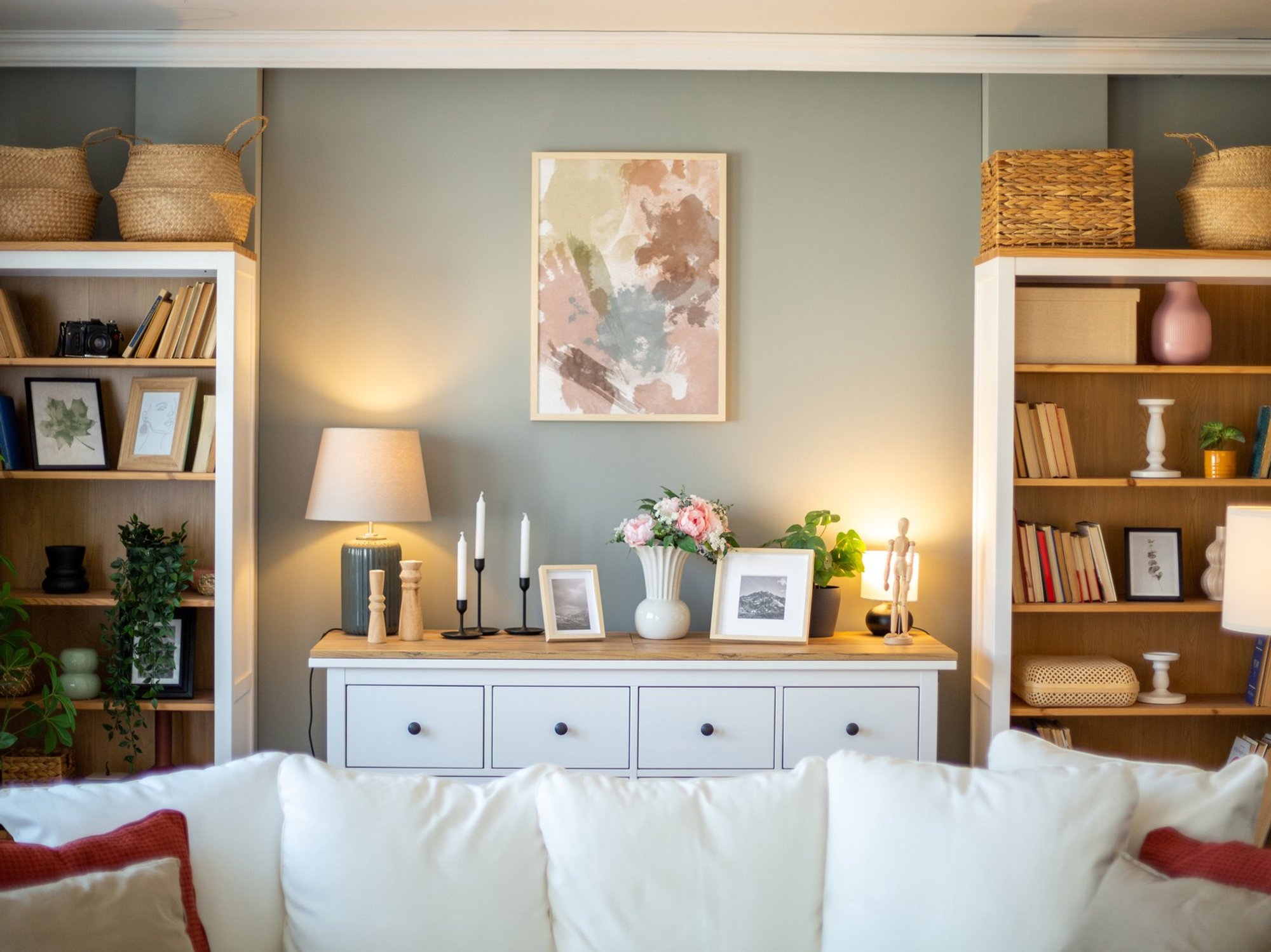 'Lived-in' living room with books, wall art, and plants