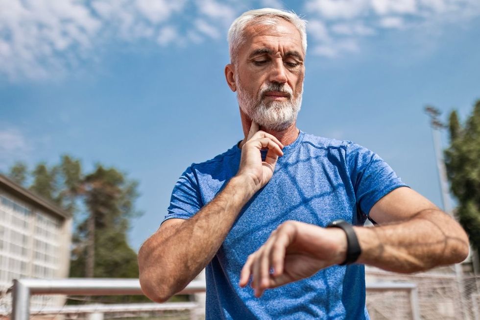 MAN CHECKING PULSE
