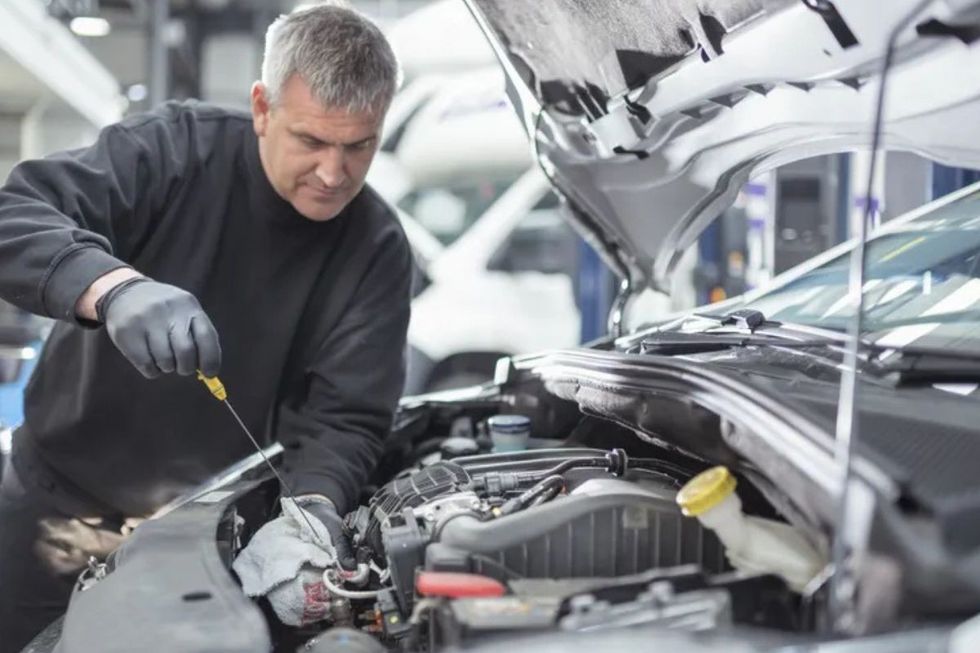 Man looking at car engine