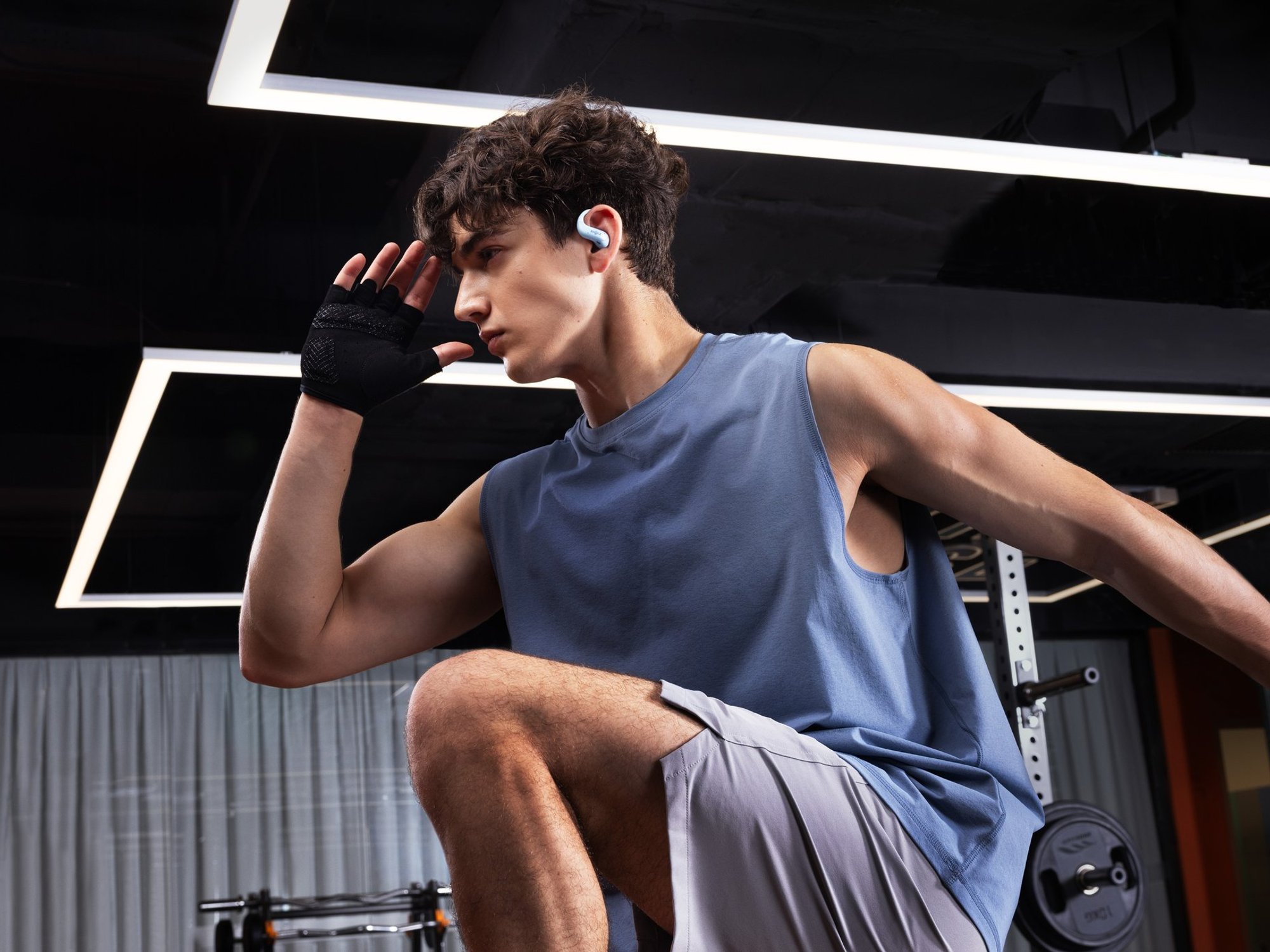 Man wearing OpenFit Air 2 earbuds
