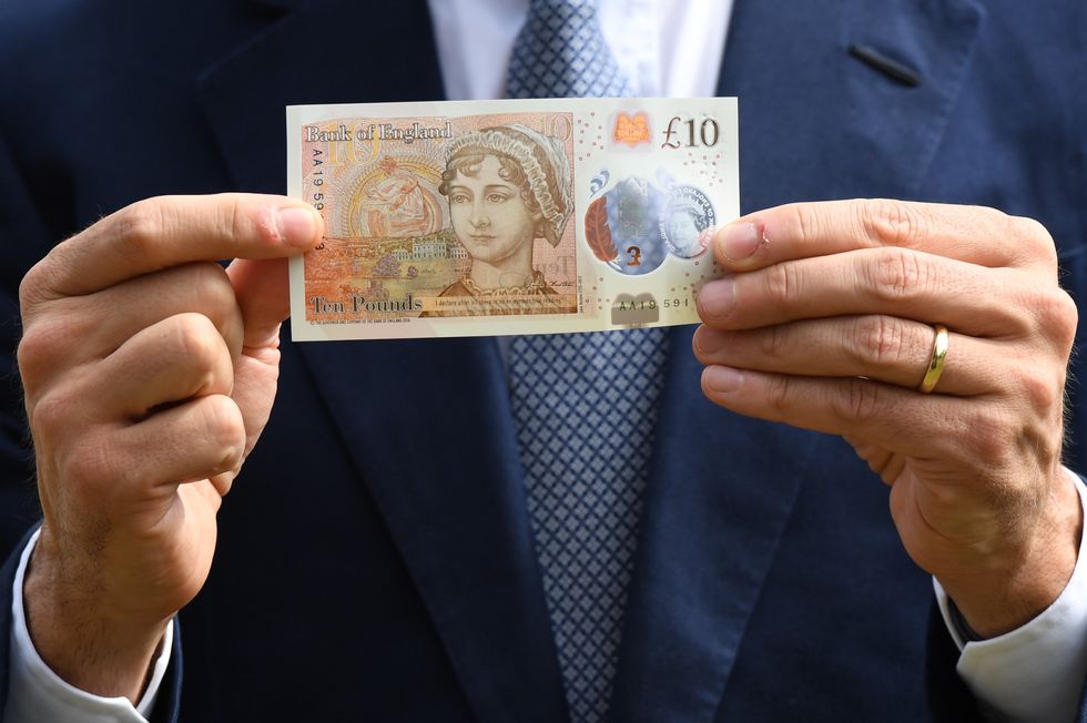 Mark Carney holding a \u00a310 banknote featuring Jane Austen