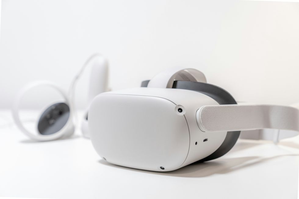 meta quest 2 headset pictured with its two controllers by its side