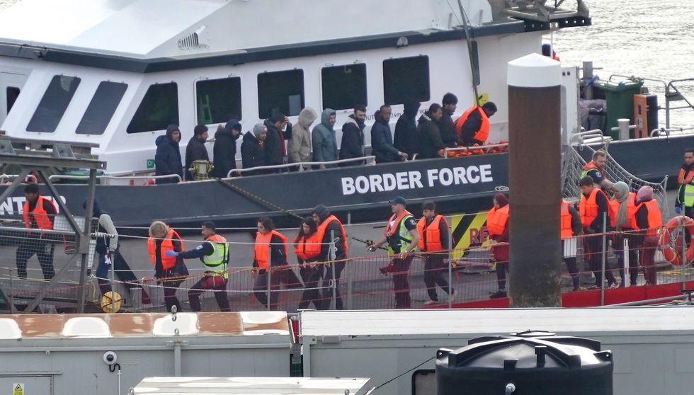 Migrants being led off ship