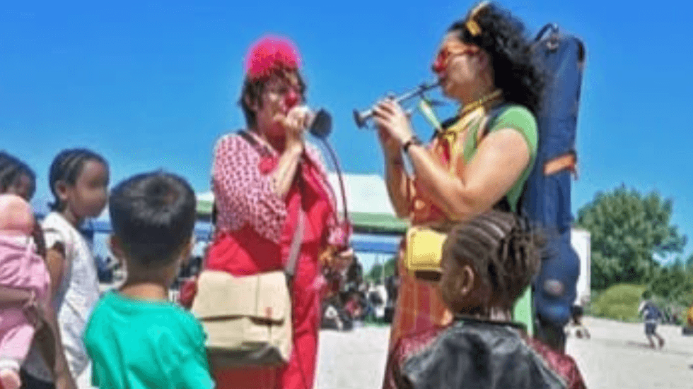 Ms Quetel and her colleague at a migrant camp in Dunkirk in July, describing it as a 'beautiful and cheerful day'