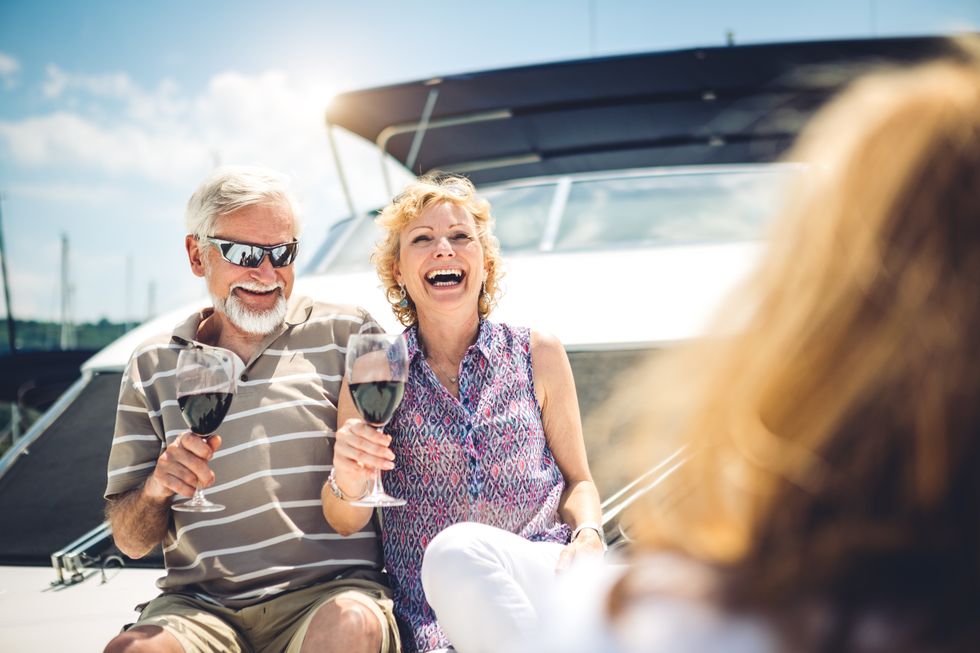 Older couple drinking wine on cruise ship