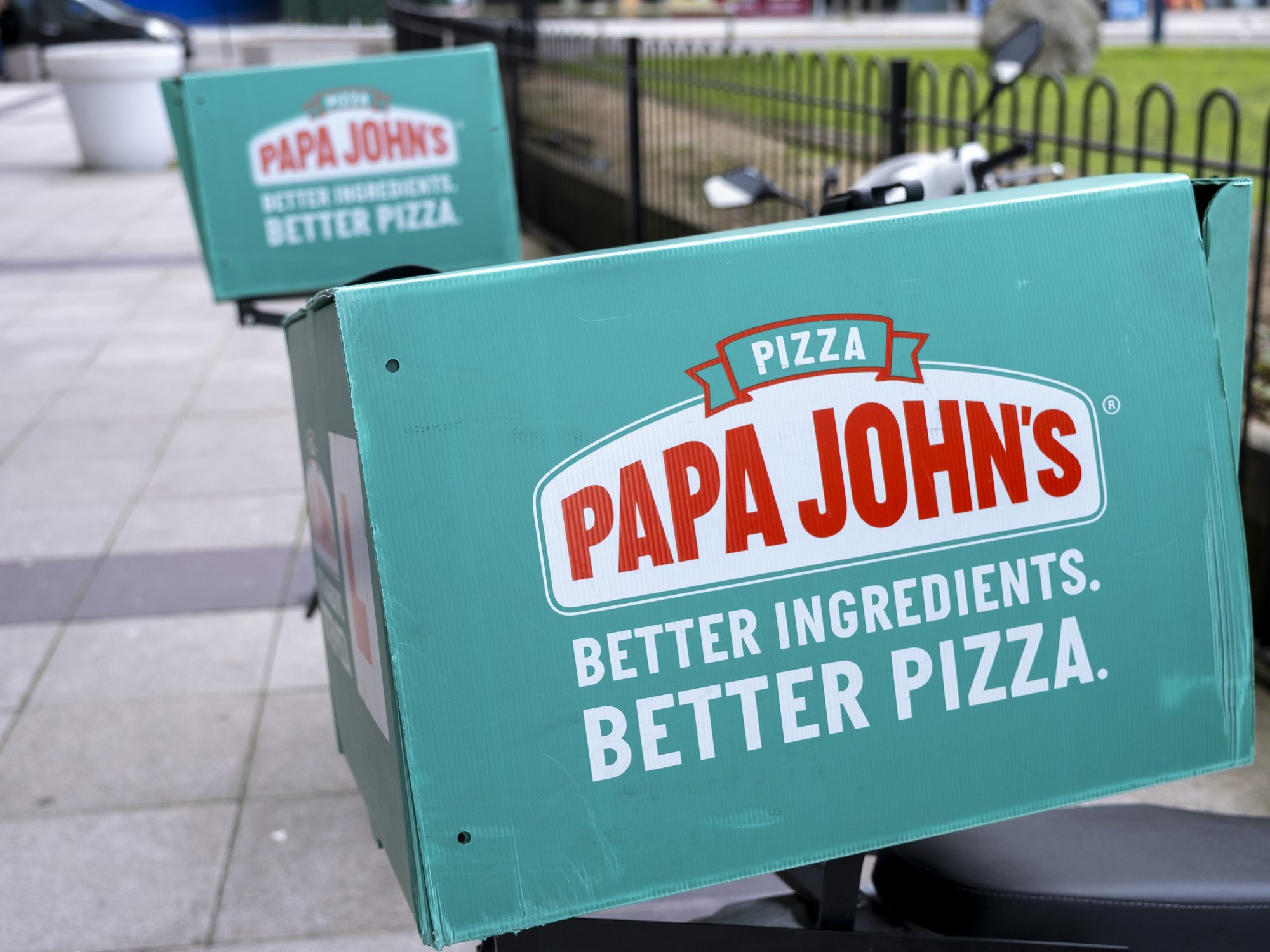 Papa John's pizza chain logo on delivery bike