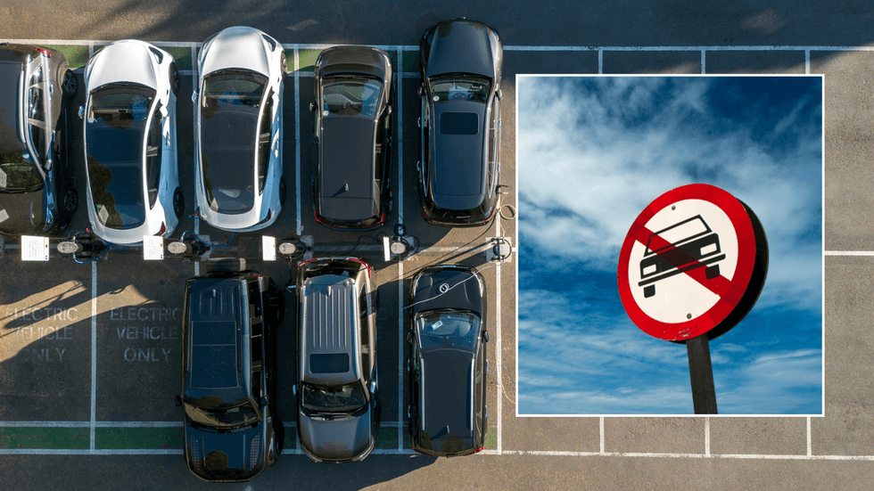 Parked car and car ban sign