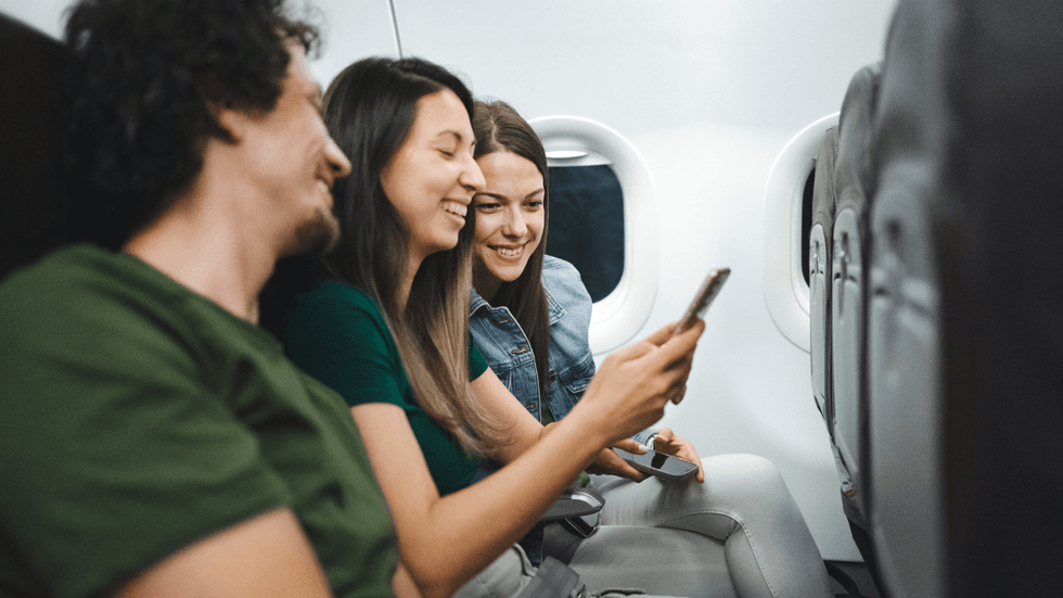 Passengers on phone on plane
