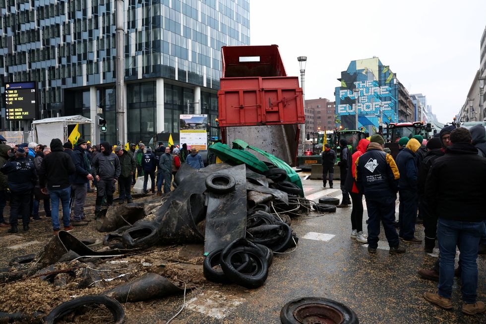 People gather during a protest of European farmers