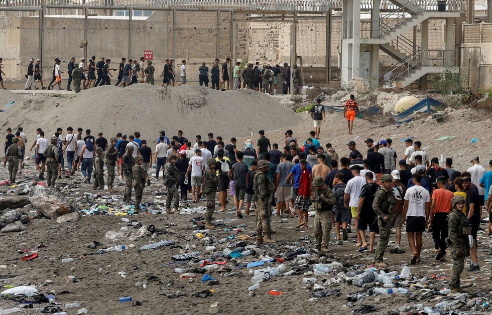 People walk towards the border with Morocco leaving Spain,