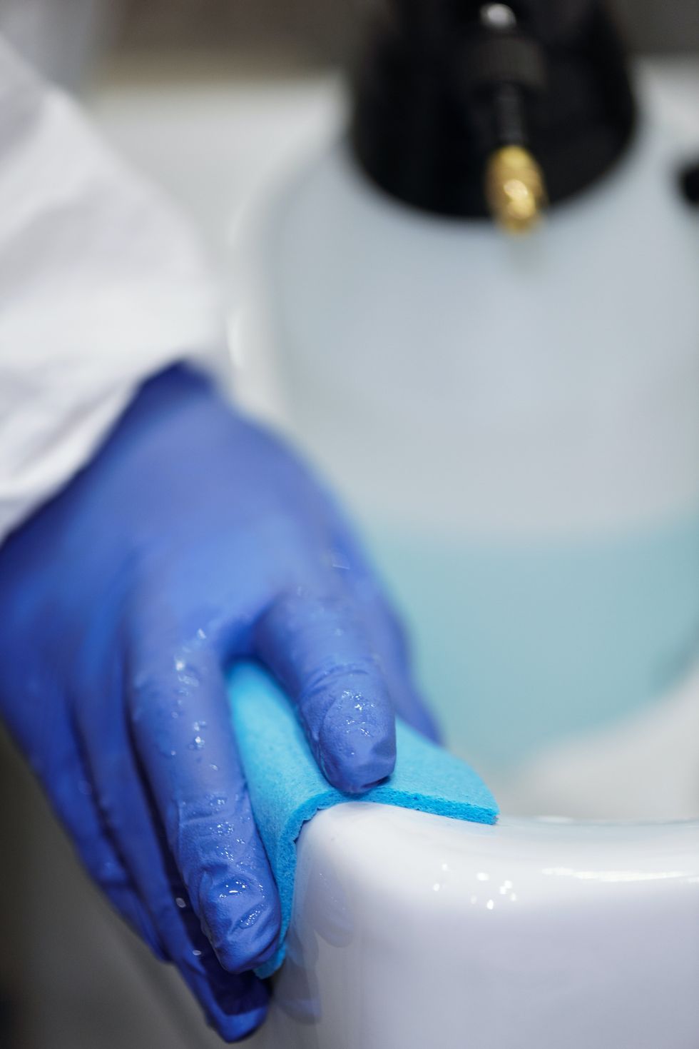 Person cleaning sink