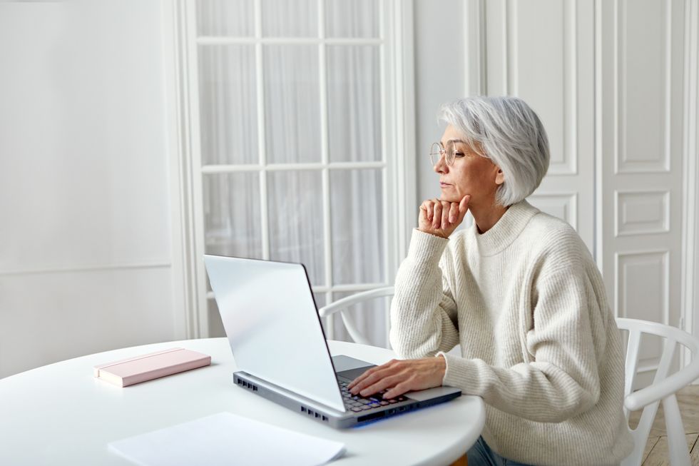 Person looks at laptop to get state pension forecast