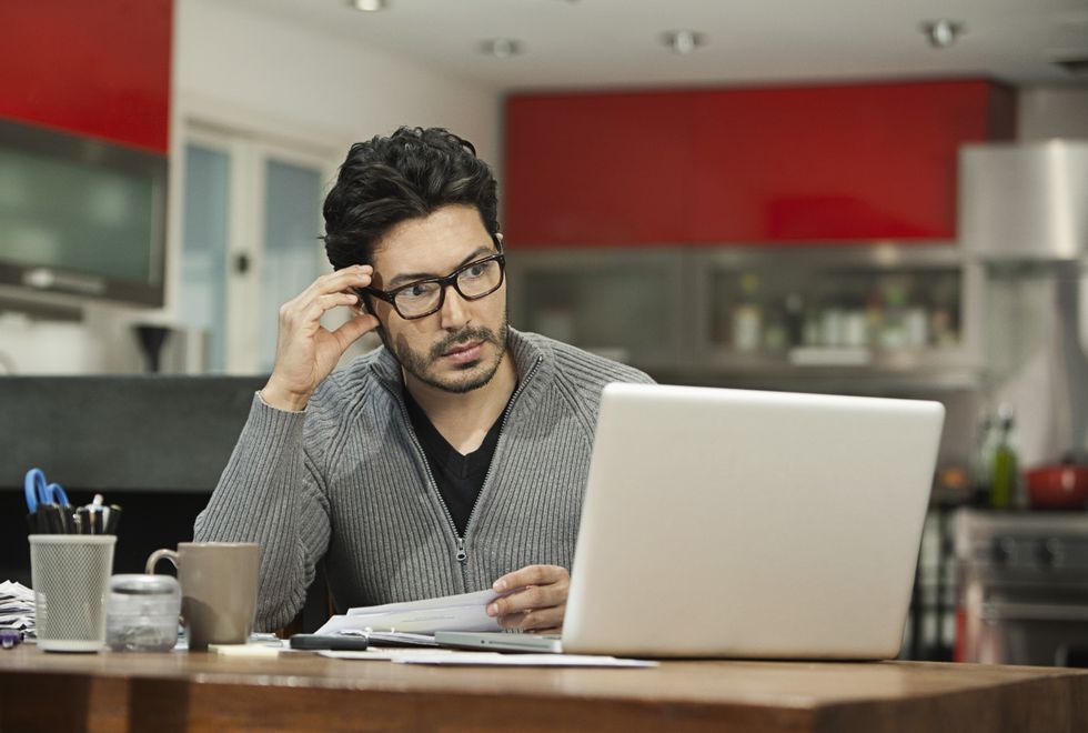 Person looks at laptop