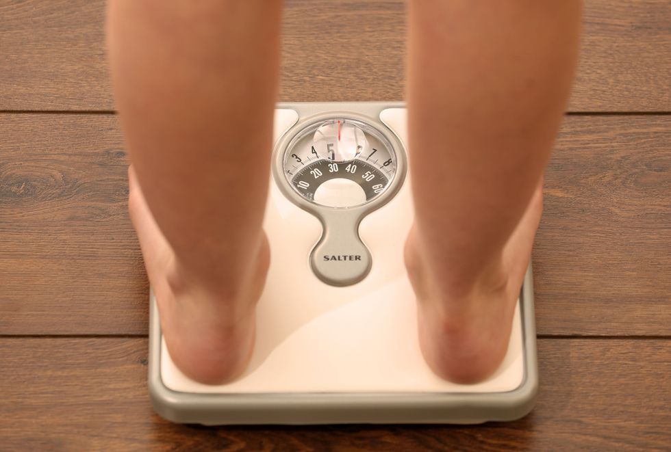 person standing on scale