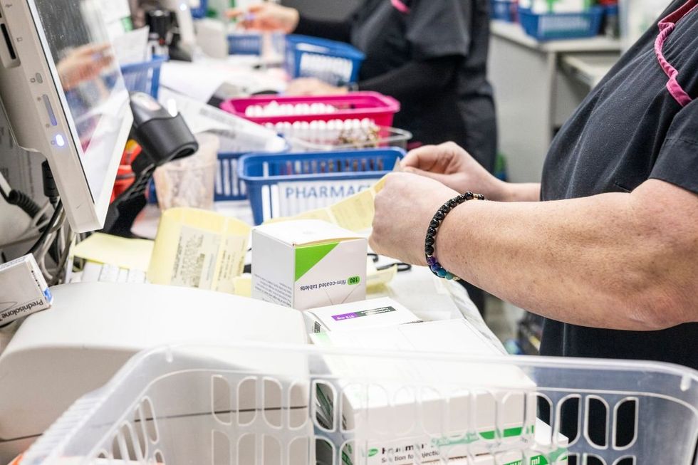 PHARMACIST PREPARING PRESCRIPTION