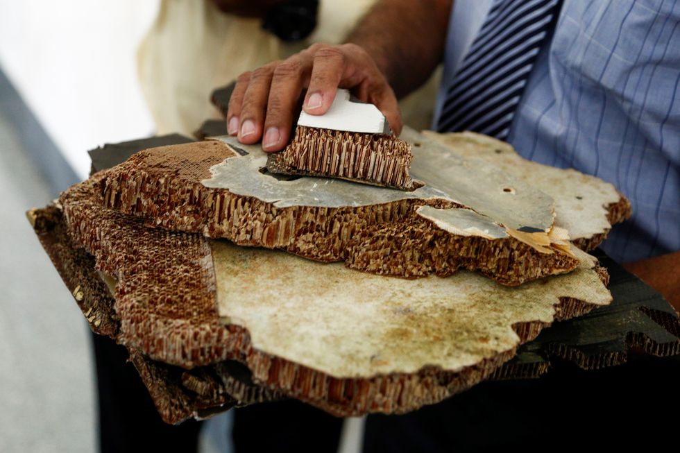 Pieces of debris found in Madagascar, believed to be from flight MH370 were shown to media members before handing over to Malaysia's Transport Minister Anthony Loke in Putrajaya on November 30, 2018.