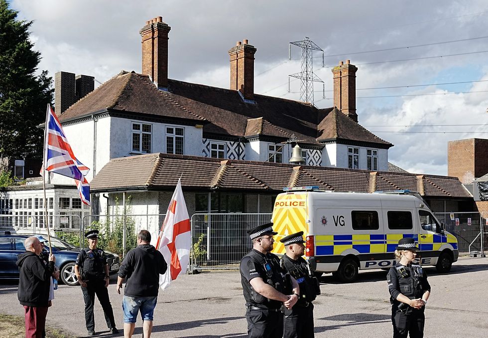 Police stood outside the Bell Hotel in Epping