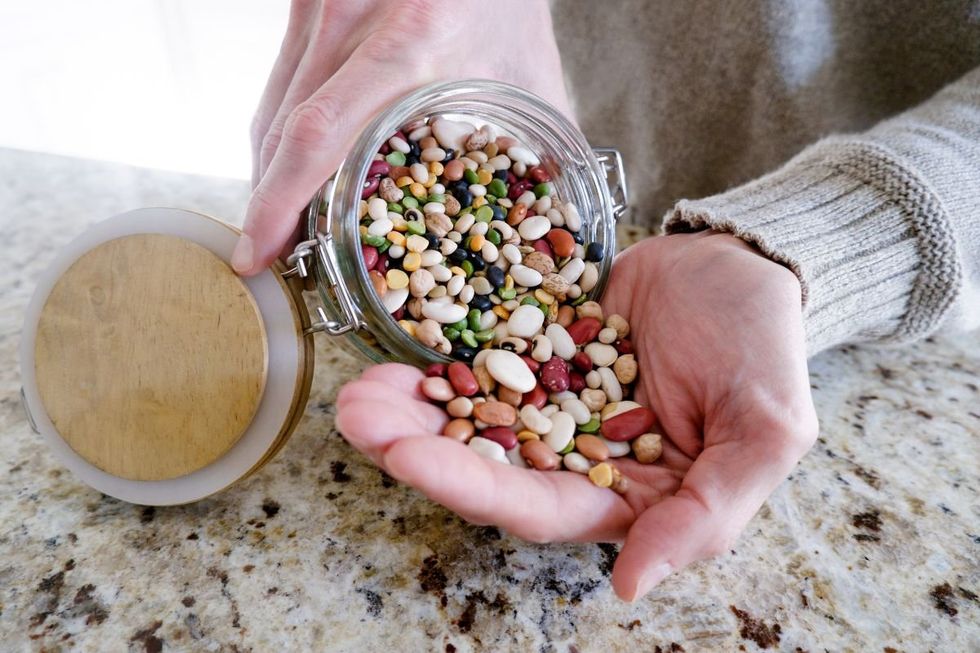 POURING BEANS INTO HAND