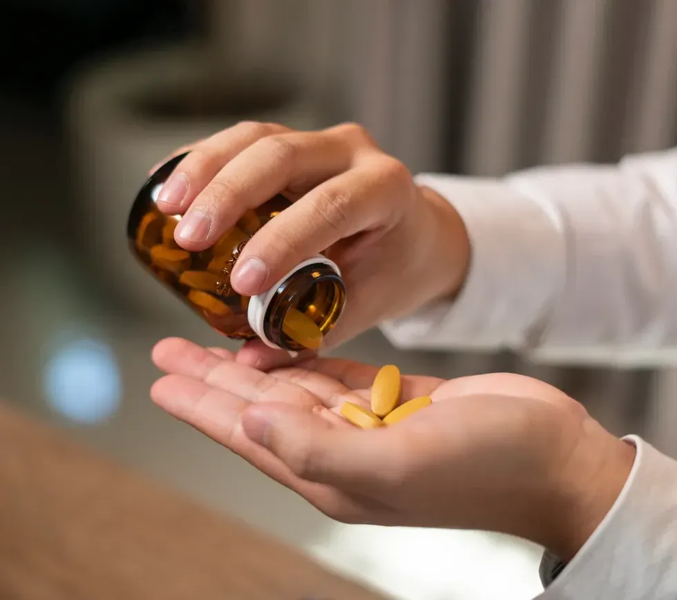 Pouring supplements into hand
