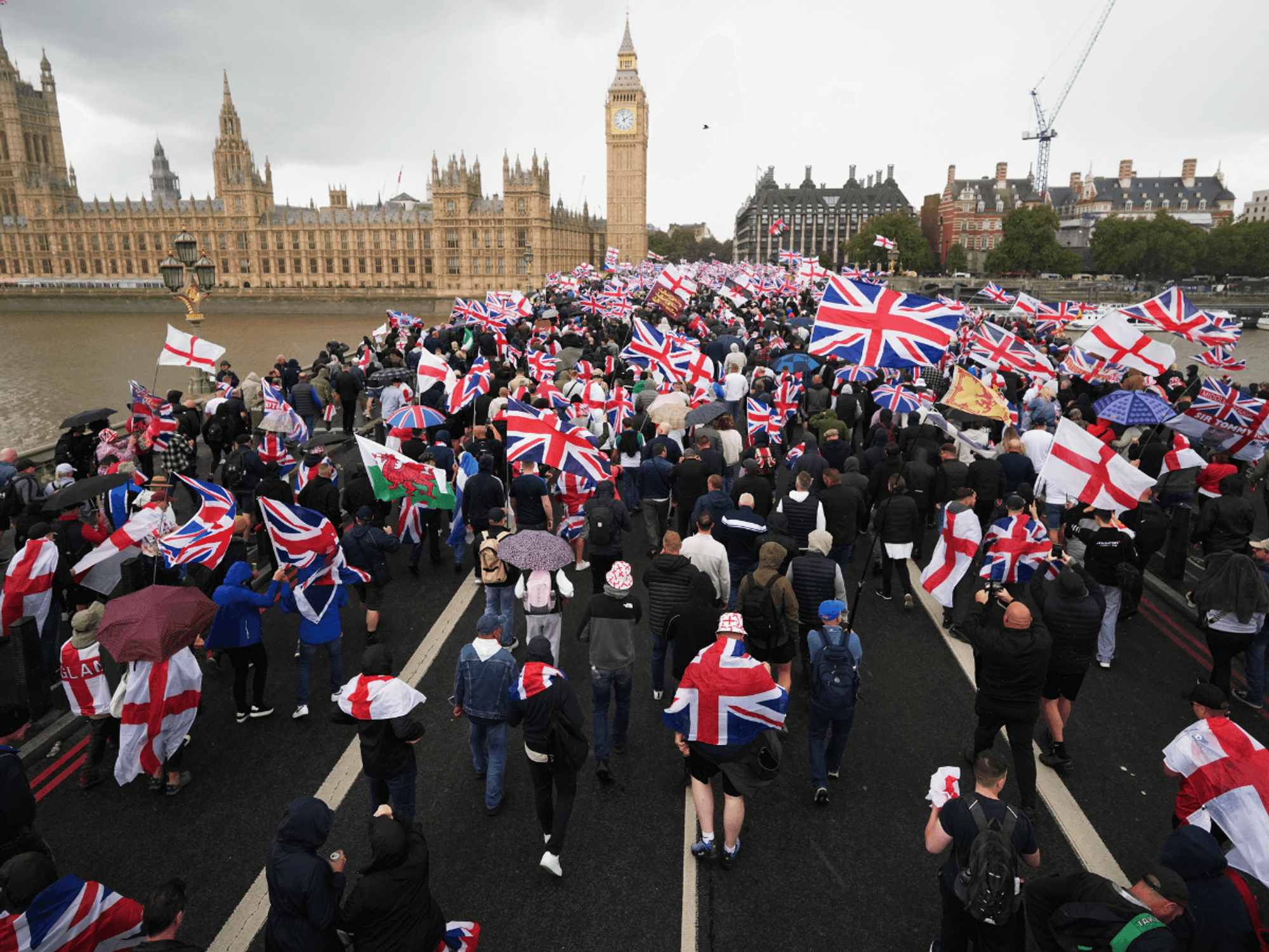 Protesters hold Union flags on bridge