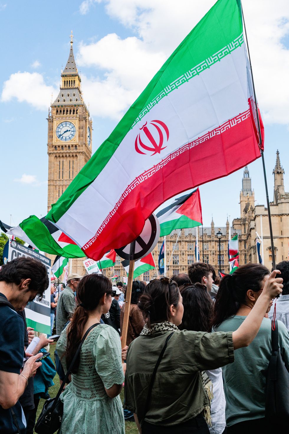 Protesters in Parliament Square waving Iranian flags