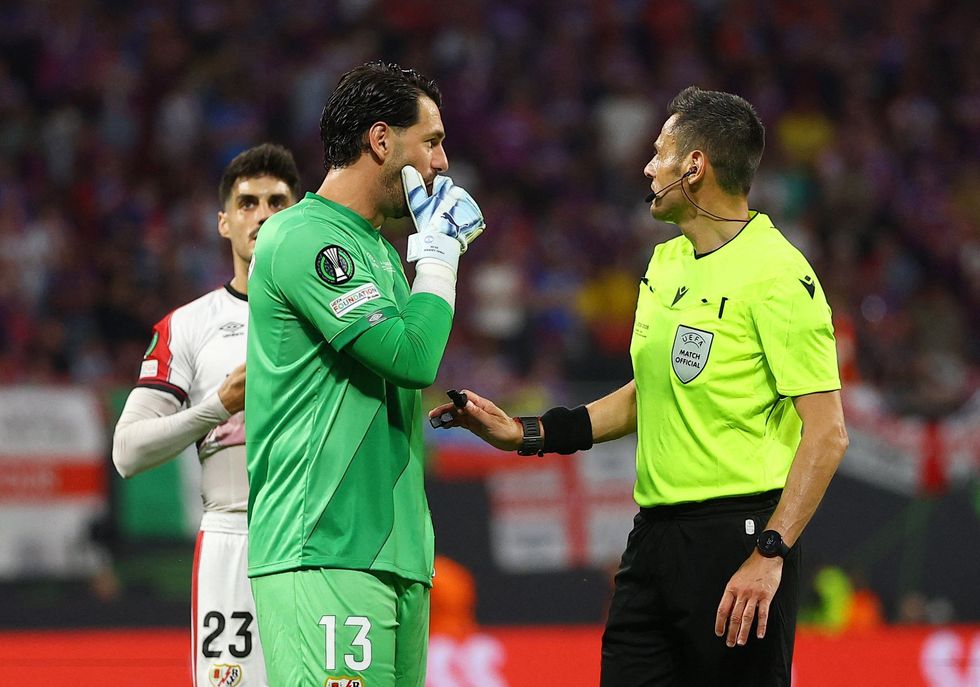 Referee Maurizio Mariani was trying to get the game back underway, but the Rayo goalkeeper refused