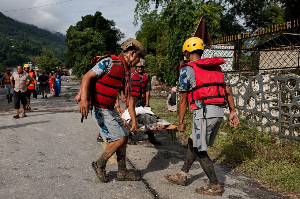 Rescuers searching for survivors in the debris-strewn valleys and hillsides of Nepal