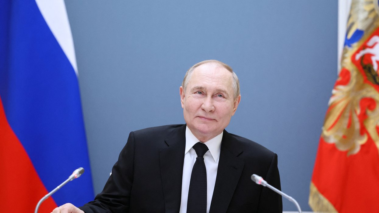 Russian President Vladimir Putin holds a meeting with large families from various Russia's regions via video link at the Kremlin in Moscow