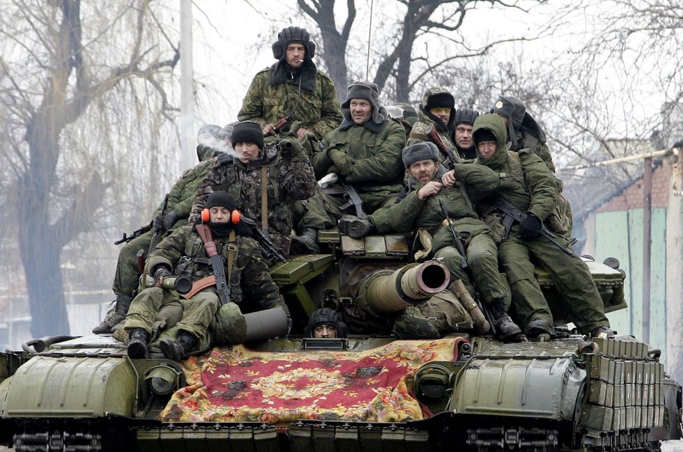 Russian soldiers pile up on a tank