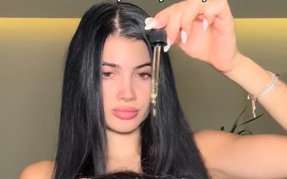Selina oiling hair
