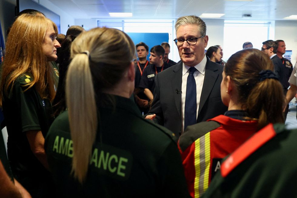 Sir Keir Starmer accompanied by ambulance crewmembers