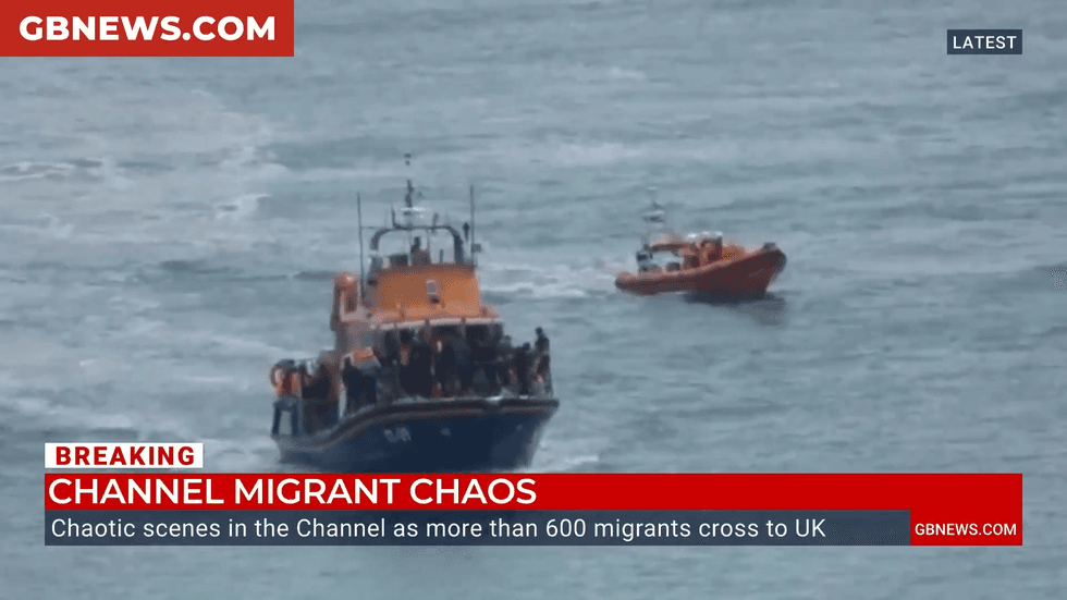 Small boat migrants are shepherded to the English coast
