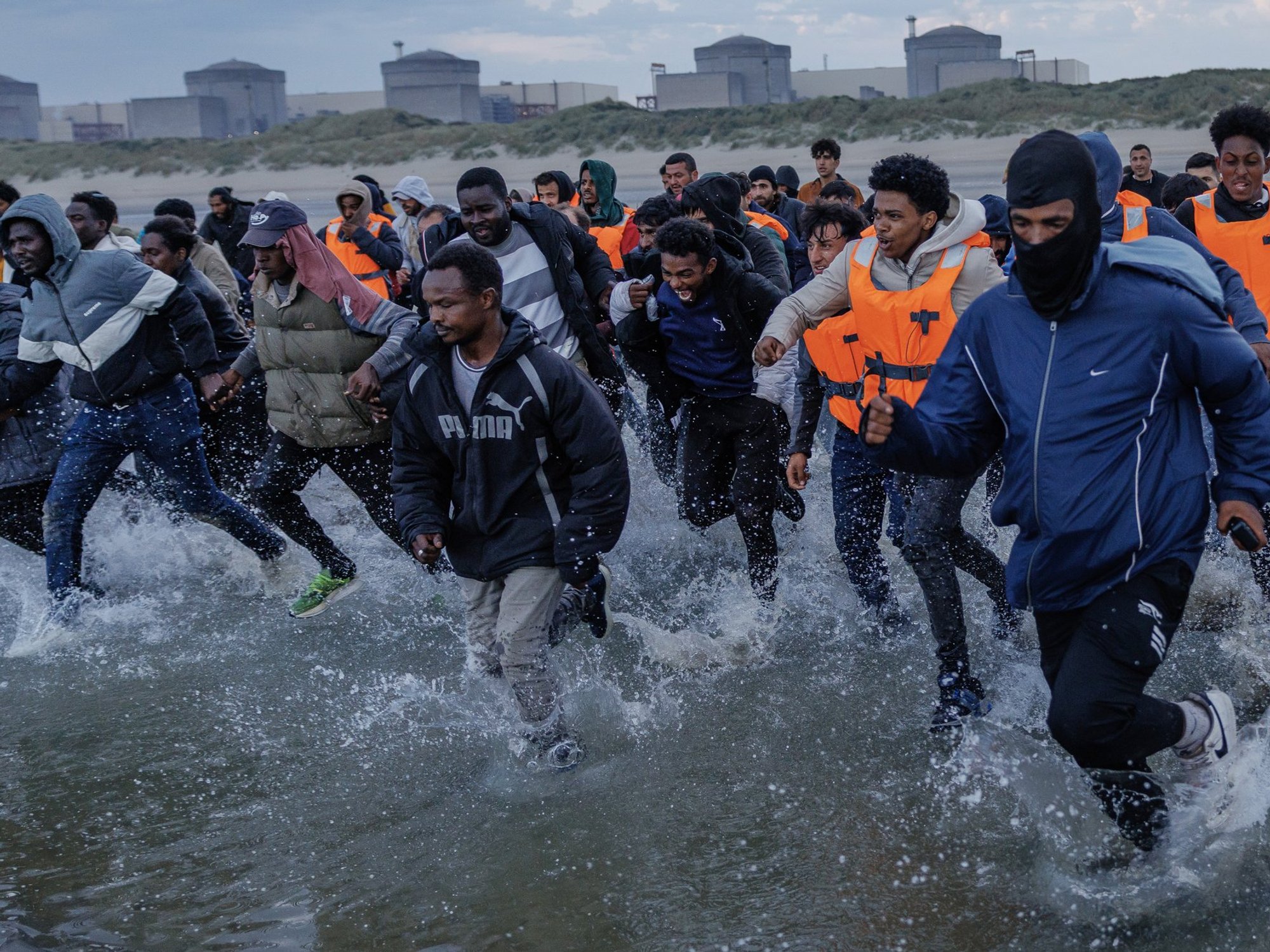 Small boat migrants on beach