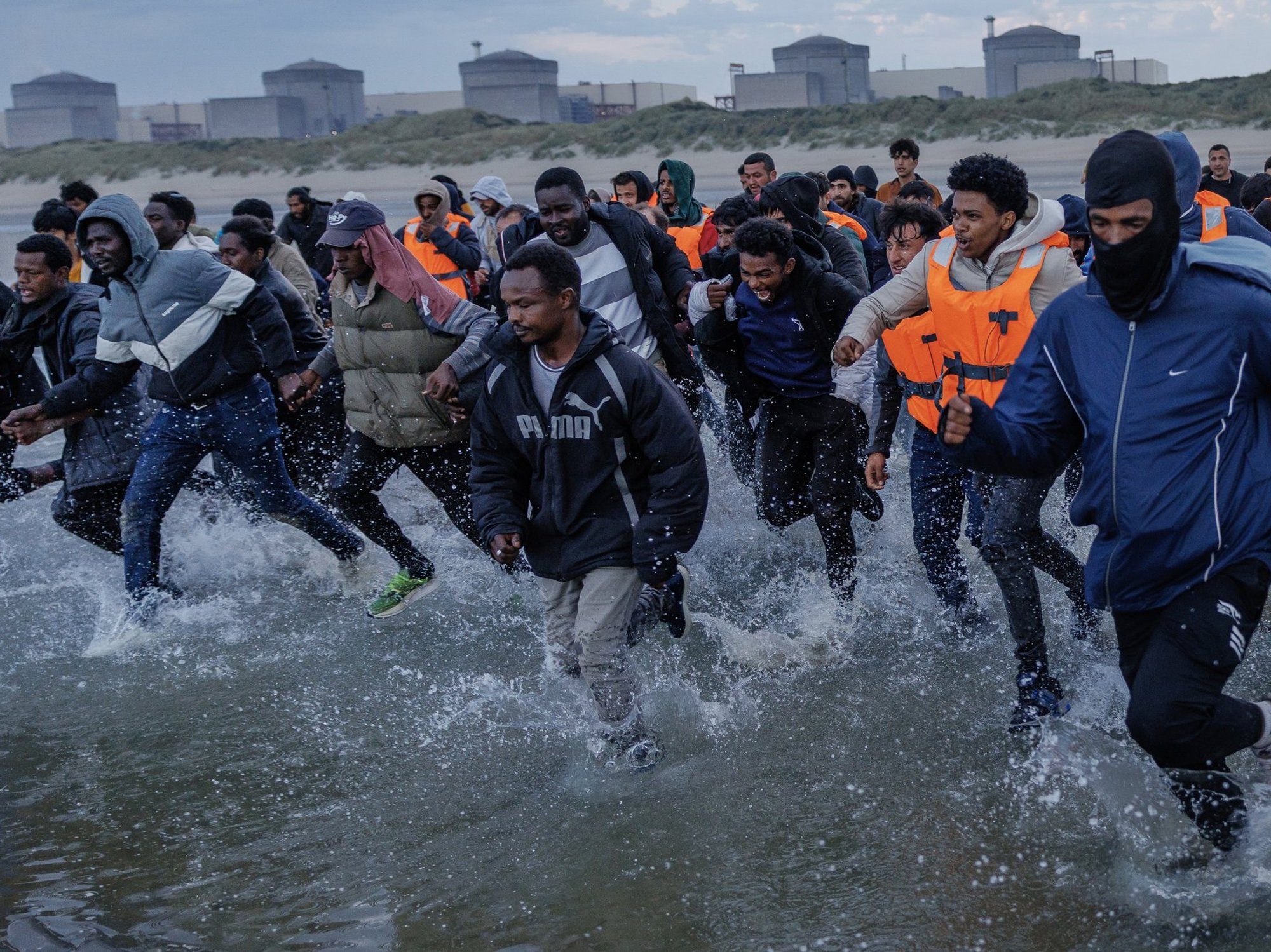 Small boat migrants on beach