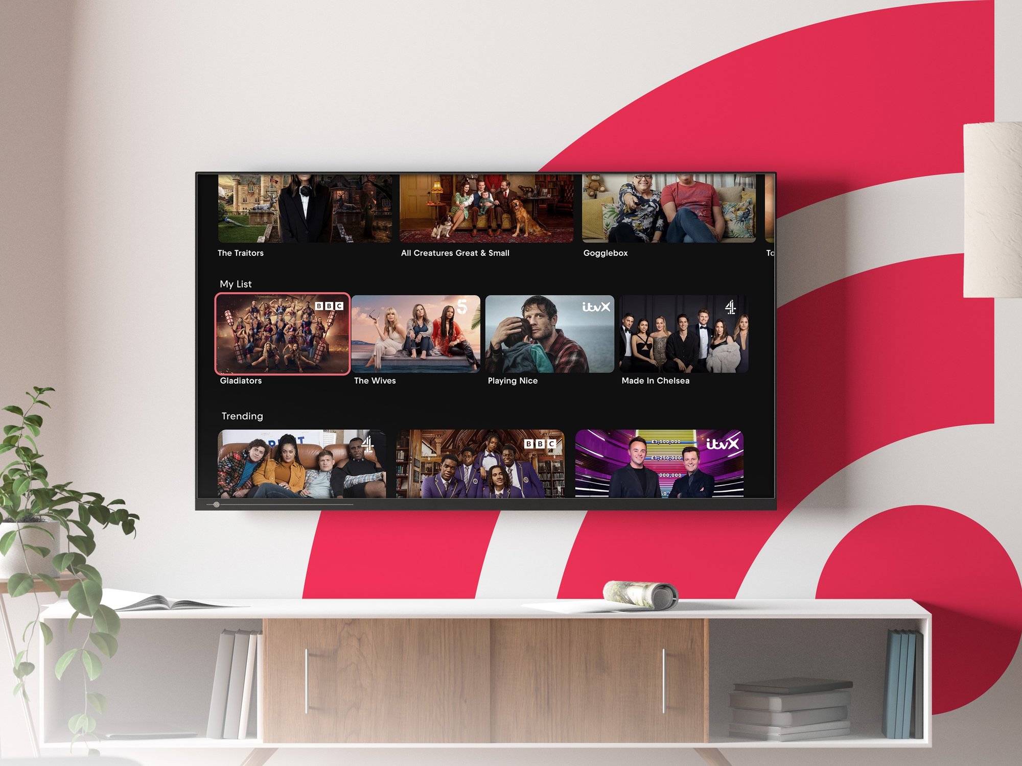 Smart TV wall-mounted with the Freely software on-screen and Netgem logo in the bottom corner