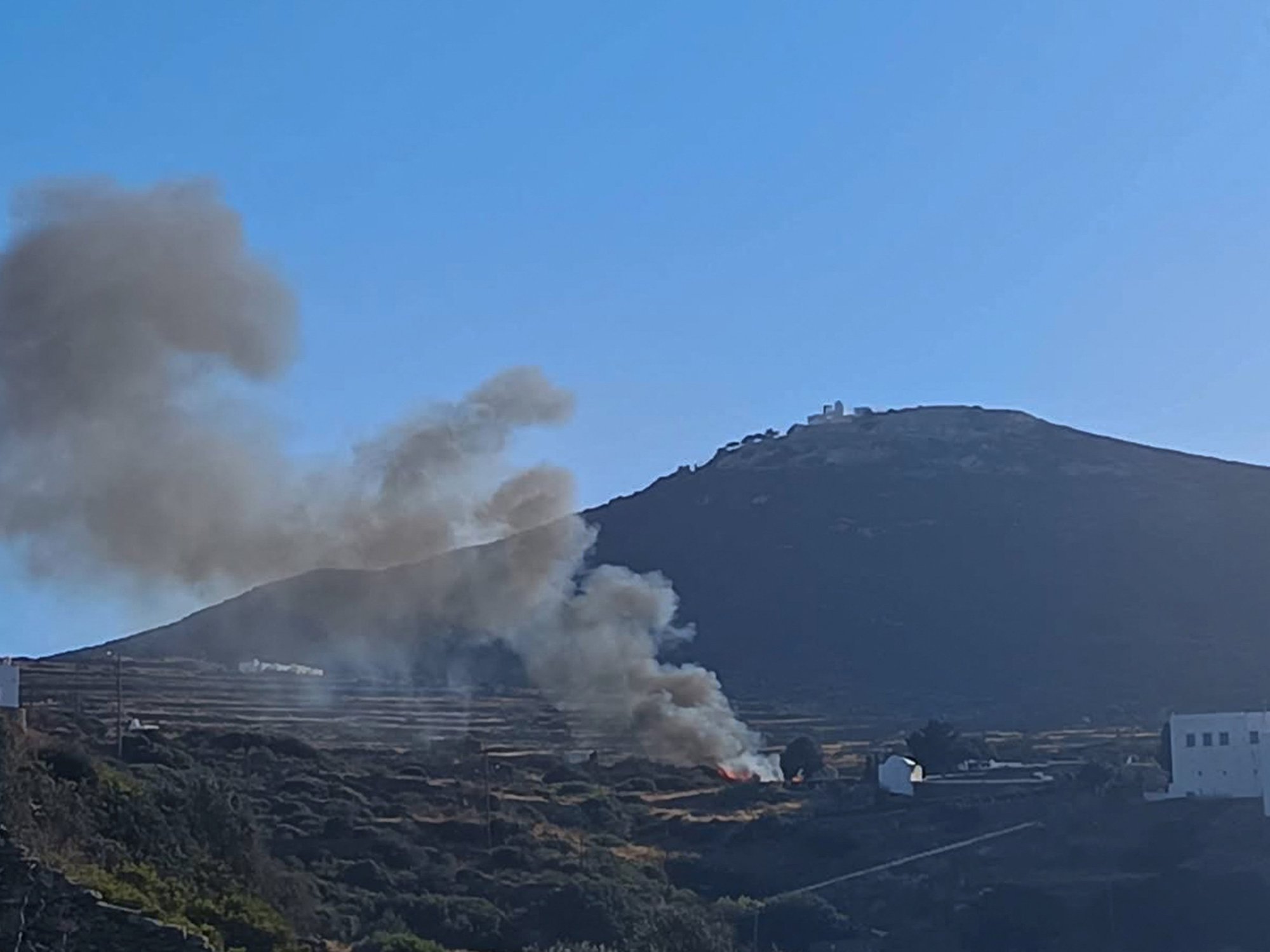 Smoke billows on hilltop