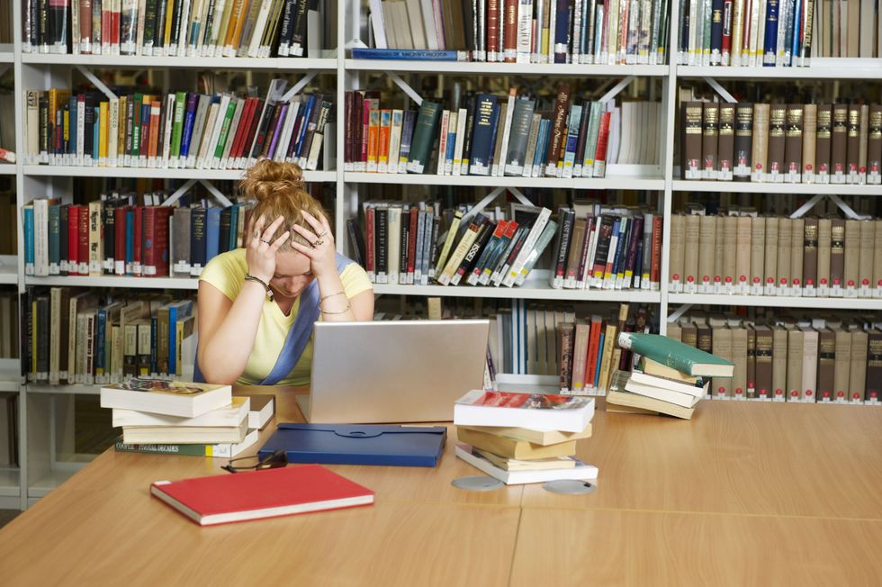Student with books in library