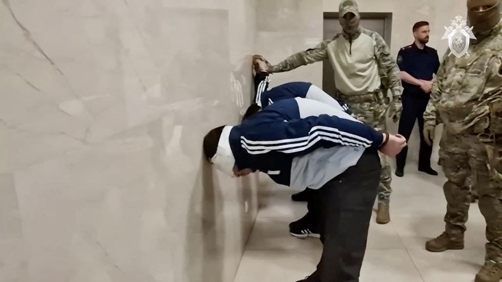 Suspects in the Crocus City Hall shooting are escorted inside the Russian Investigative Committee headquarters