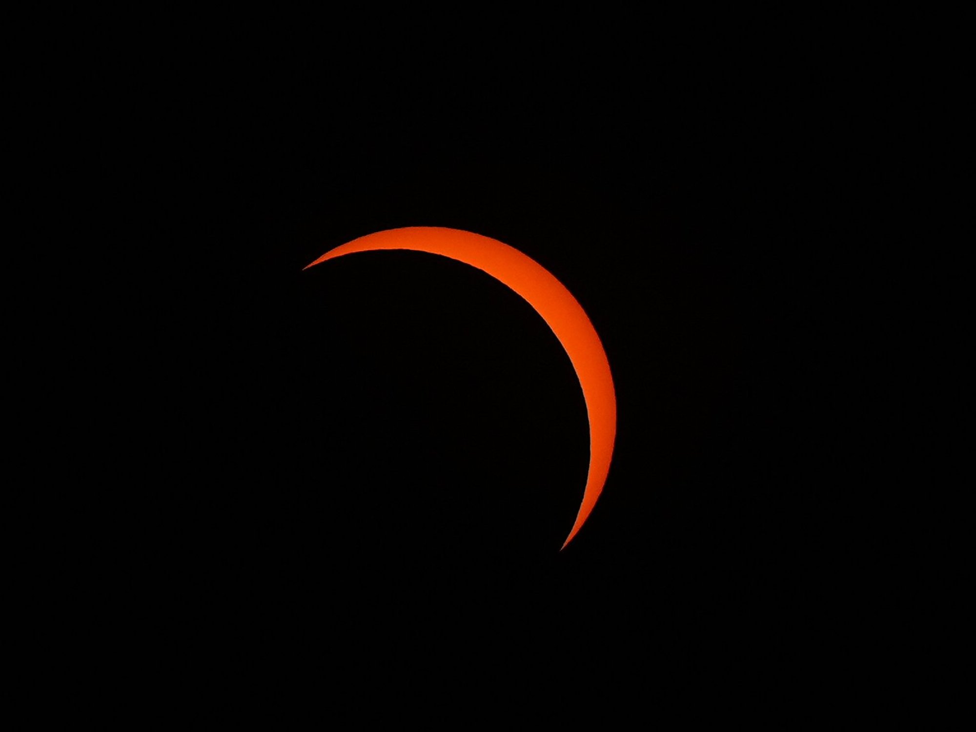 The Moon passes in between the Earth and the Sun during the solar eclipse as seen from King's Stairs Gardens in Bermondsey, south London